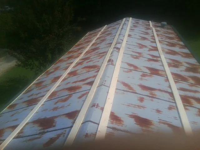 Rusted metal roof panels with new wood purlins before replacement — Storm Damage Roof Repair in Stem by Roofing Brothers